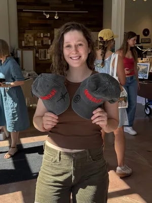 Valucap Pigment Dyed - Customer holding up two hats